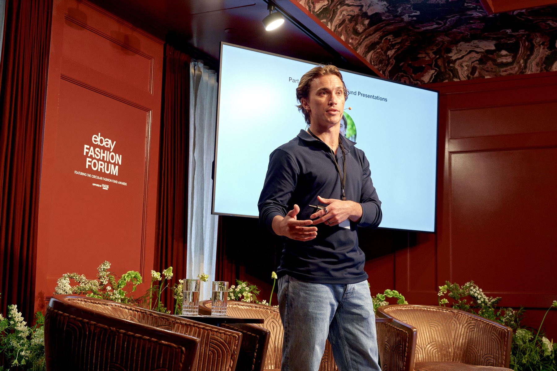Brandon Steidley presenting Silhouet on stage at the eBay Fashion Forum, beside the Circular Fashion Fund Awards banner