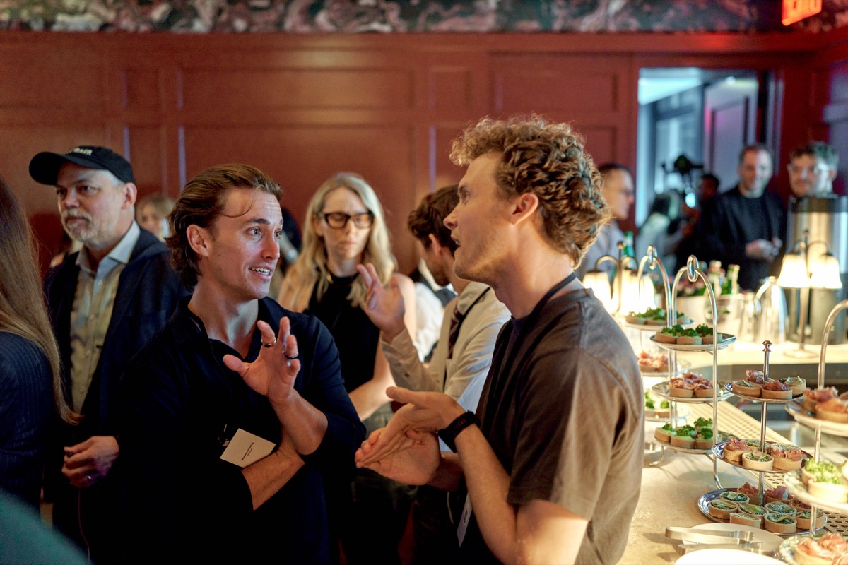 Two attendees deep in conversation at the eBay Fashion Forum reception in New York