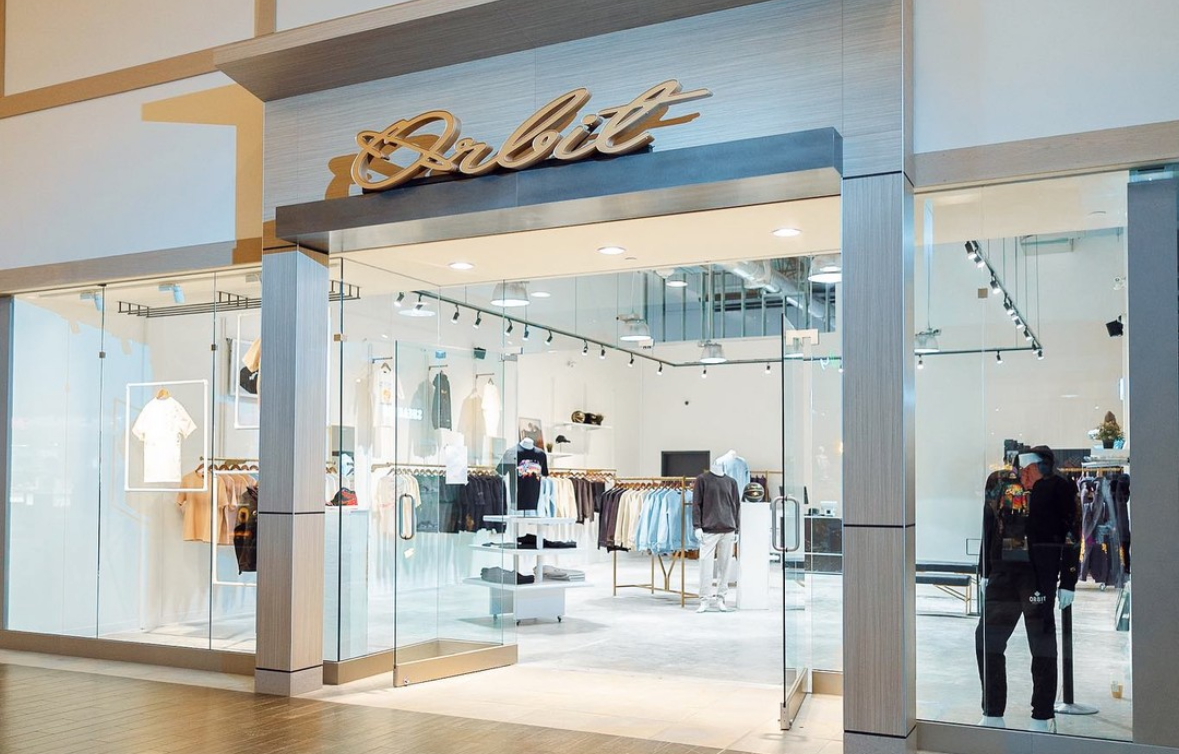 The Orbit Collective storefront with its script sign over the entrance
